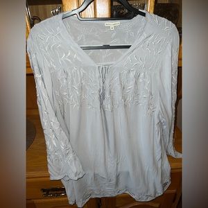 Grey blouse with flowering detail.